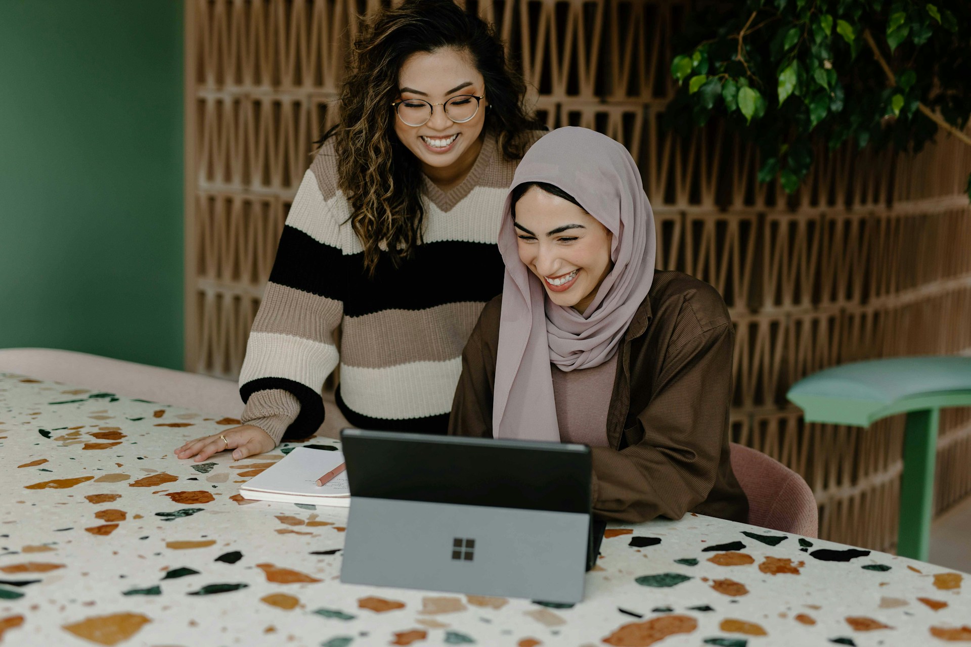 Two women sitting at table reviewing mortgage offers